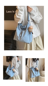Detail of light blue canvas tote bag with drawstring buckle and plush coffee cup charm