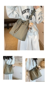 Detail of olive green nylon tote bag featuring drawstring closure and front utility pockets