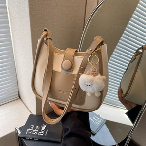 Chic beige and khaki bucket bag with plush sheep charm and gold lettering detail