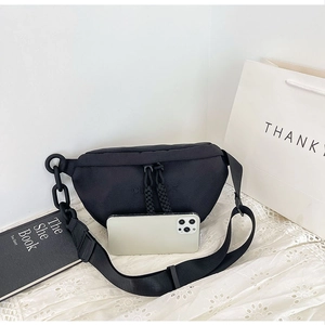 Detail of black nylon crescent bag with chunky chain and smartphone size comparison