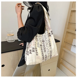 Detail of canvas tote bag with Chinese calligraphy on a model for a literary aesthetic