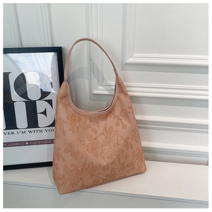 Detailed close-up of apricot pink hobo bag featuring 3D floral embossed texture