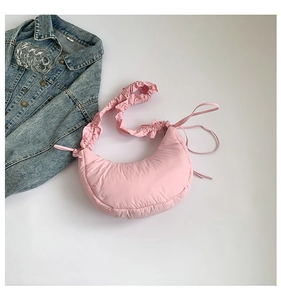 Detail of pink pleated crescent cloud bag with ruffled strap and nylon texture