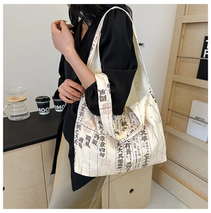 Detail of canvas tote bag featuring traditional Chinese calligraphy and seal stamps