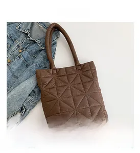 Close-up of dark brown quilted tote bag with diamond stitching and soft puffer texture