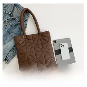 Detailed view of dark coffee quilted tote bag with puffer style triangular stitching
