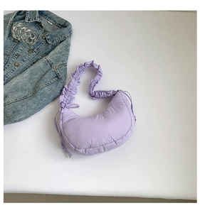 Detail of light purple pleated shoulder bag with soft quilted texture and drawstrings