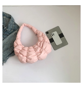 Detailed flat lay of pink pleated cloud bag with tablet and phone for size reference