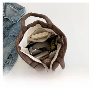 Detailed interior of a quilted puffer tote bag showing spacious storage for daily essentials