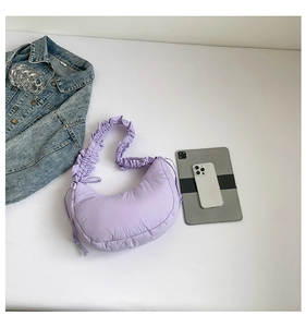 Detailed view of light purple quilted cloud bag with scrunchie strap and drawstring accents