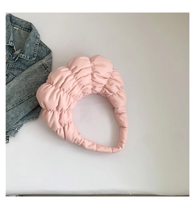 Detail of pink puffy headband with quilted clouds texture and soft padded design