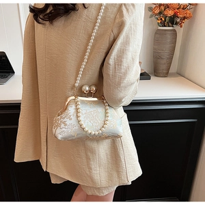 Detail of vintage embroidery pattern and pearl clasp on the Chinese style handbag