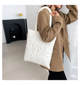 Detail shot of the white quilted puffy tote bag featuring premium triangular stitching
