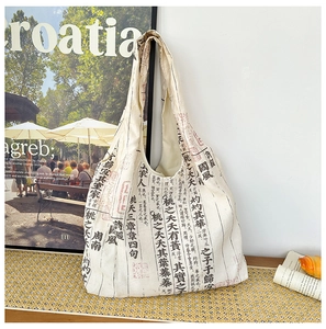 Detailed close-up of canvas tote bag featuring traditional Chinese calligraphy art print