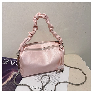 Detail of pink satin Boston bag with pleated handle and silver chain strap