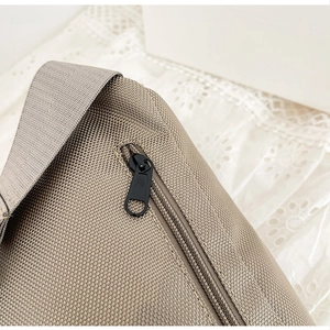 Detailed macro view of khaki canvas fabric texture with smooth black metal zipper