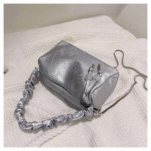 Detail of silver pillow bag featuring tree branch texture and pleated cloud handle