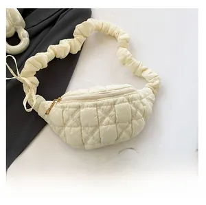 Detail of off-white quilted puffer bag featuring a unique scrunchie shoulder strap