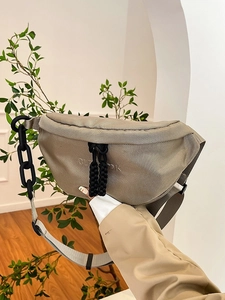 Versatile beige half-moon canvas chest bag with a sporty chain strap for women
