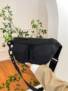 Versatile black canvas chest bag with chunky chain strap and adjustable nylon belt for women