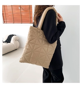 Detail of khaki quilted tote bag featuring geometric stitching and soft padded straps