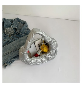 Silver quilted cloud bag open showing large capacity with phone and umbrella