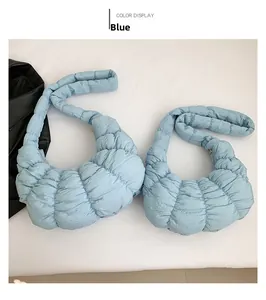 Flat lay of two quilted blue puff dumpling bags with shoulder straps and metal details