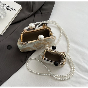 Detailed view of vintage jacquard handbags with elegant pearl straps and secure kiss locks