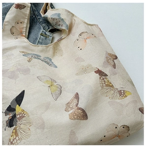 Close-up of vintage butterfly print on canvas tote bag with textured cotton fabric
