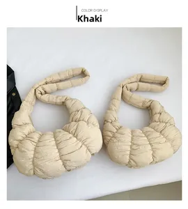 Detail view of khaki quilted dumpling bag showing the puffy texture and soft pleated fabric
