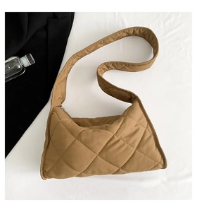 Gros plan sur un sac bandoulière marron matelassé avec texture à losanges sur tissu