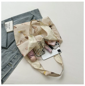 Interior view of floral canvas tote bag showing large capacity for umbrella and phones