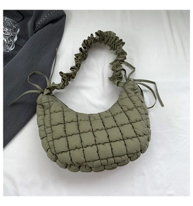 Detailed close-up of the quilted olive green dumpling bag showing high-quality stitching