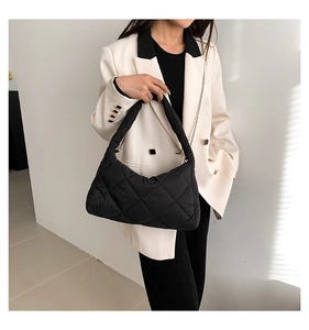 Détail du sac d'épaule matelassé noir en nylon avec bandoulière et chaîne métallique