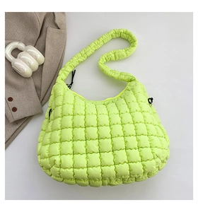 Close-up of neon green quilted bubble shoulder bag with textured puffer lattice pattern