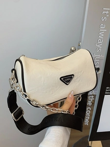 Chic beige cylinder pillow bag with wide shoulder strap and metal chain detail