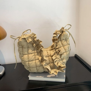 Chic beige quilted crescent dumpling bag with ruffle edges and soft shoulder strap