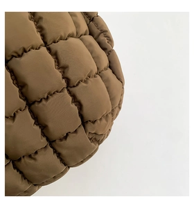 Macro shot of dark brown quilted bubble bag material showing puffed square texture