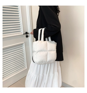 Detail of the white quilted puffy shoulder bag made of lightweight padded nylon material