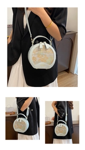 Detail of light blue circular handbag with classical garden jacquard and BOWEN logo