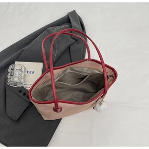 Top view of large tote bag showing interior zip pocket and beige-burgundy contrast detail