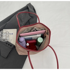 Detailed interior of a large pink tote bag showing storage space for daily essentials