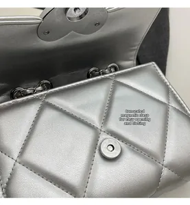 Detail of the hidden magnetic closure on the silver quilted chain shoulder bag