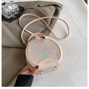 Detail of pink round bag with traditional Chinese architecture embroidery and gold logo
