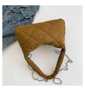 Gros plan du sac bandoulière matelassé caramel en nylon avec chaîne argentée et rembourrage