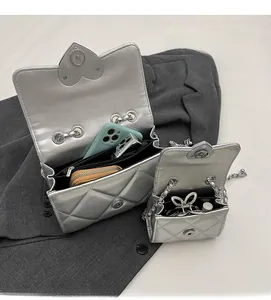 Detail of silver quilted chain bag interior showing multiple spacious compartments