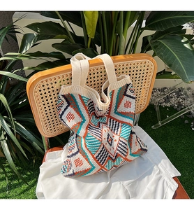 Detail of bohemian knit tote bag showing colorful geometric patterns and woven texture