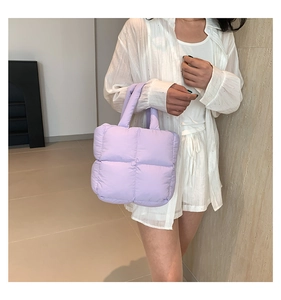 Close-up of lavender quilted puffer tote bag featuring soft padded texture and square pattern