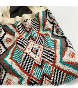 Detailed close-up of bohemian knit tote bag showing colorful geometric star patterns