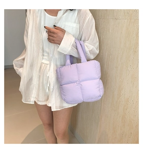 Detail of light purple quilted tote bag with soft padded texture and square stitching